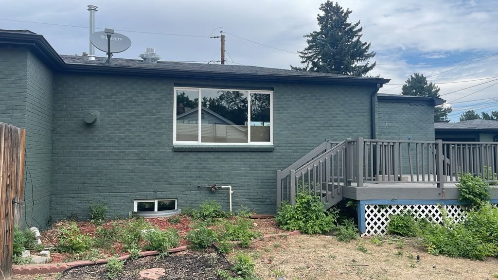 After: Denver metro · Brick ranch repaint · Deep sage green, black gutters