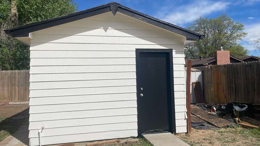 After: Denver metro · Backyard shed repaint · White with black fascia
